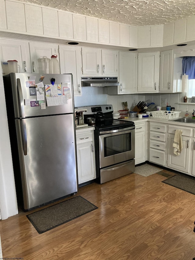 kitchen featuring white cabinetry, sink, dark wood-type flooring, and appliances with stainless steel finishes