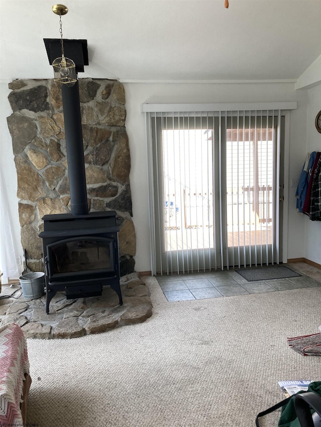 carpeted living room featuring a wood stove