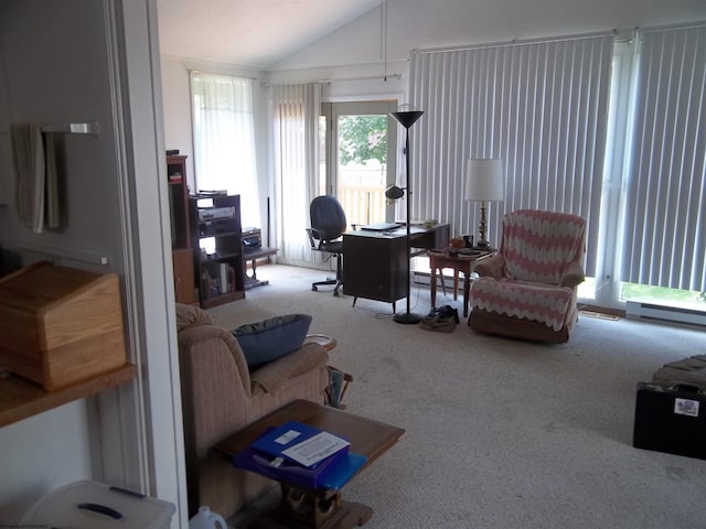 living room featuring light colored carpet and vaulted ceiling