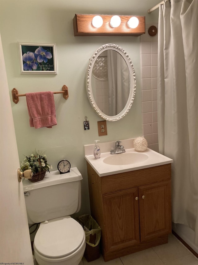 bathroom featuring walk in shower, tile patterned floors, vanity, and toilet