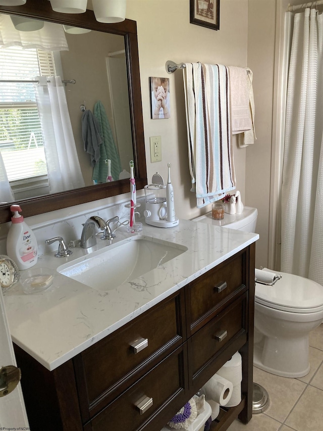 bathroom featuring vanity, tile patterned floors, and toilet