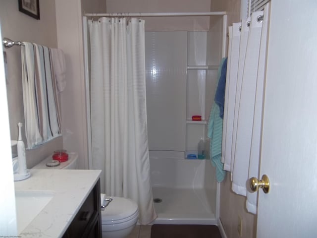 bathroom with vanity, toilet, and walk in shower