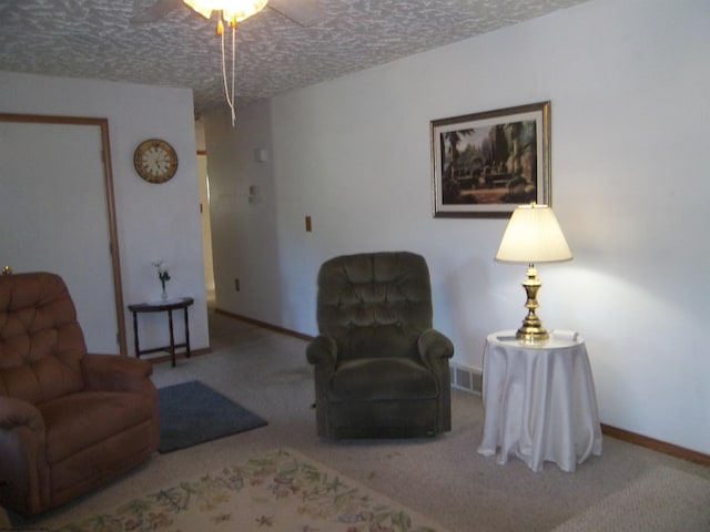 carpeted living room featuring a textured ceiling