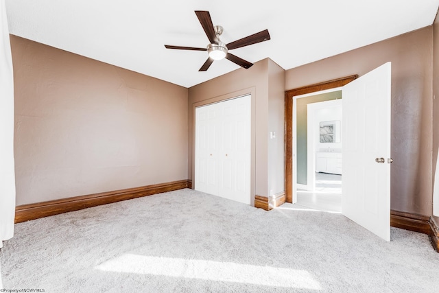 unfurnished bedroom featuring light carpet, ceiling fan, and a closet