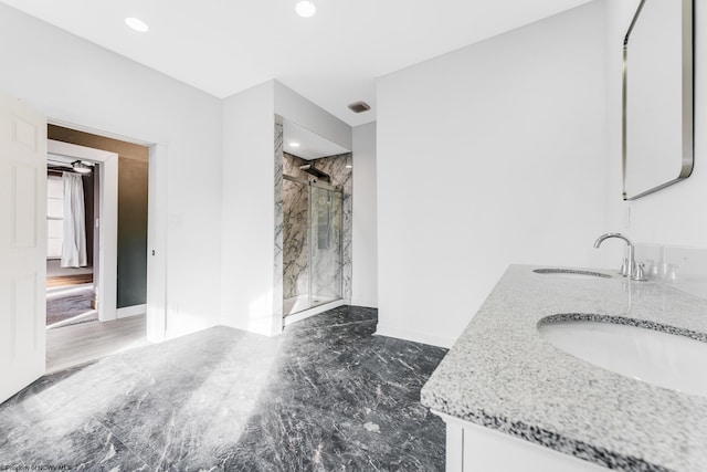 bathroom with walk in shower and vanity