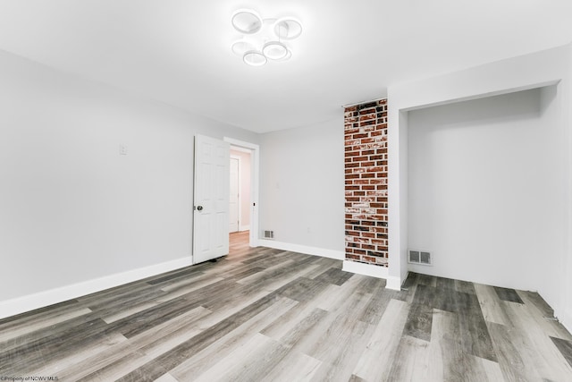 empty room with hardwood / wood-style floors