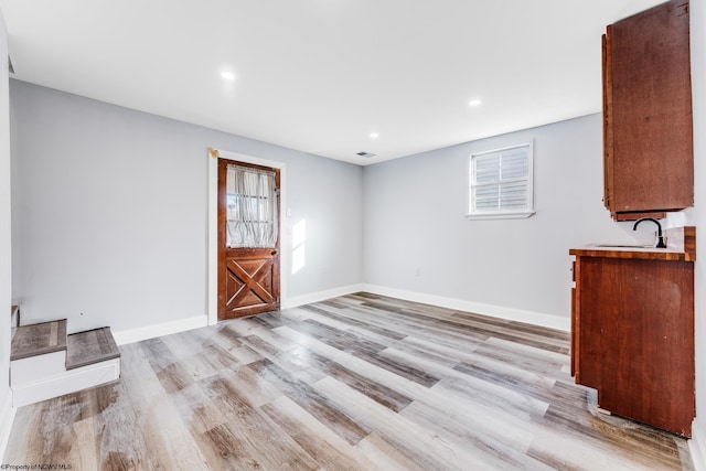 interior space with sink and light hardwood / wood-style floors