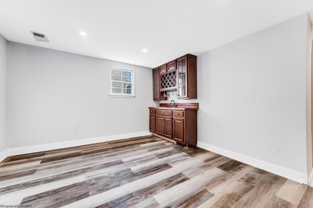 bar with light hardwood / wood-style floors