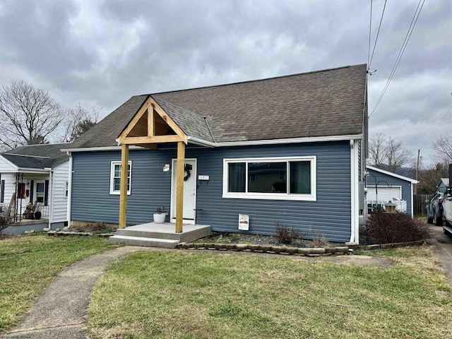 view of front of house featuring a garage and a front lawn