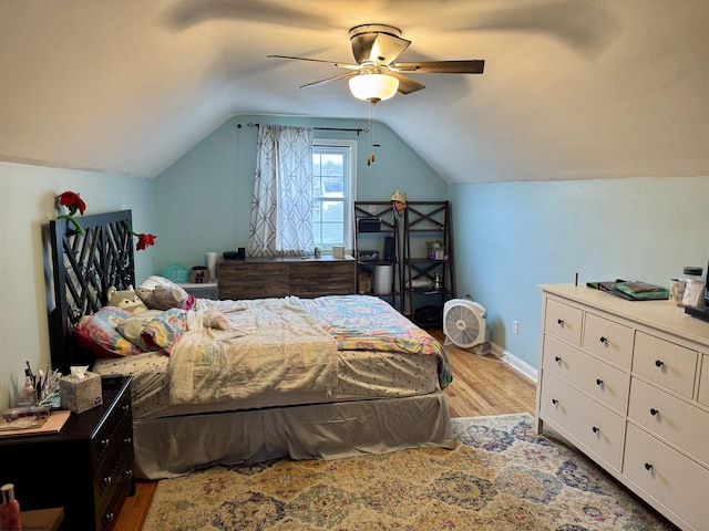 bedroom with ceiling fan, lofted ceiling, and light hardwood / wood-style flooring