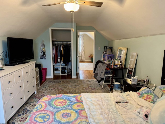 bedroom featuring dark hardwood / wood-style floors, vaulted ceiling, a closet, and ceiling fan