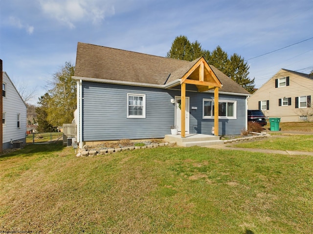 view of front of home featuring a front lawn and central air condition unit