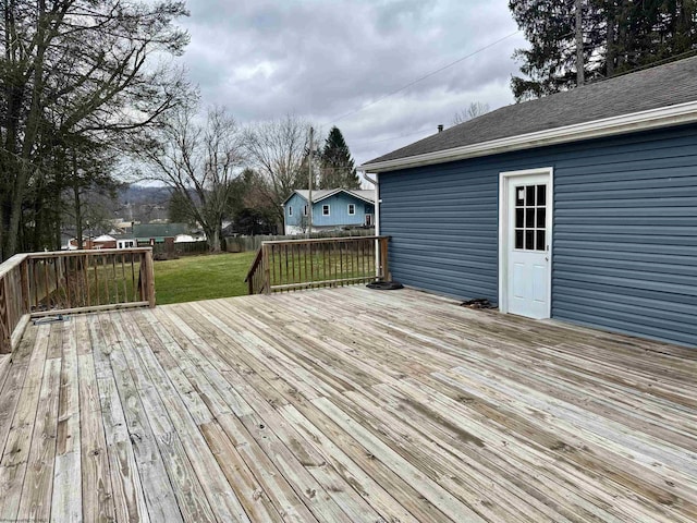 wooden deck featuring a lawn