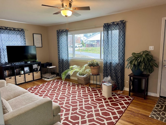 living room featuring wood-type flooring and ceiling fan