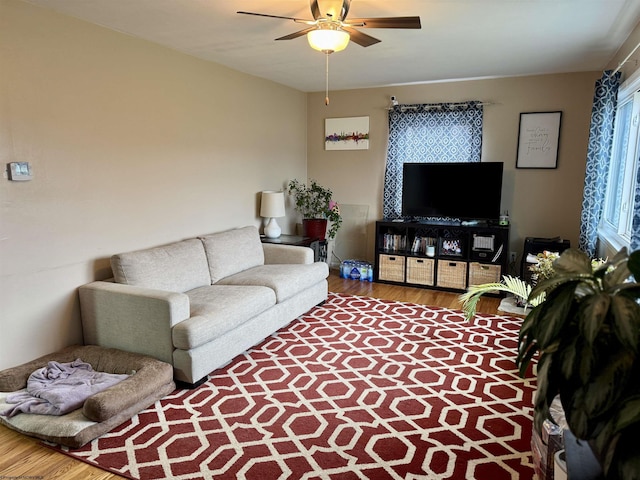 living room with hardwood / wood-style flooring and ceiling fan