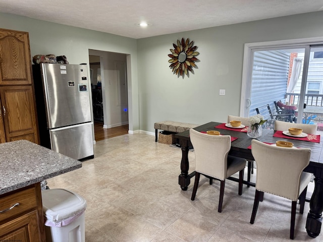 dining space featuring a textured ceiling