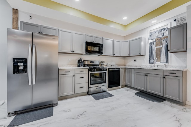 kitchen with gray cabinetry, sink, and black appliances