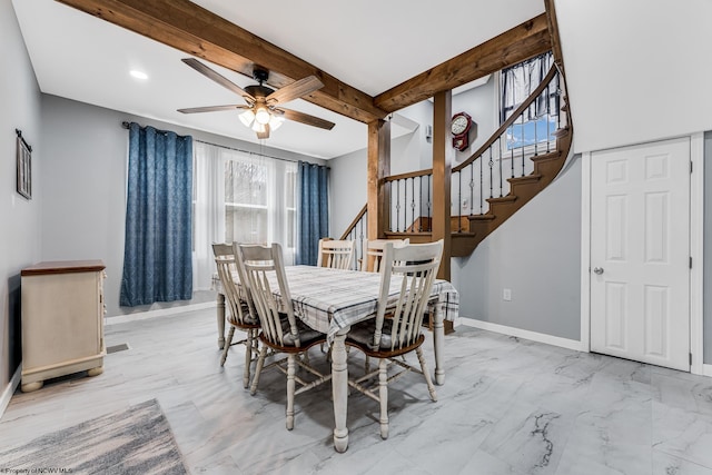 dining room featuring ceiling fan and beam ceiling