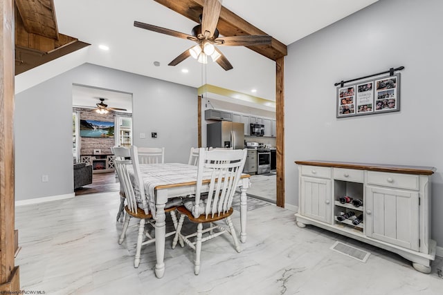 dining room with a fireplace and ceiling fan