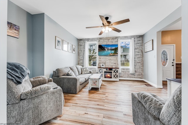 living room with ceiling fan and light hardwood / wood-style flooring