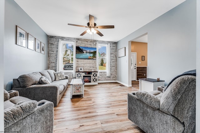 living room featuring ceiling fan and light hardwood / wood-style floors