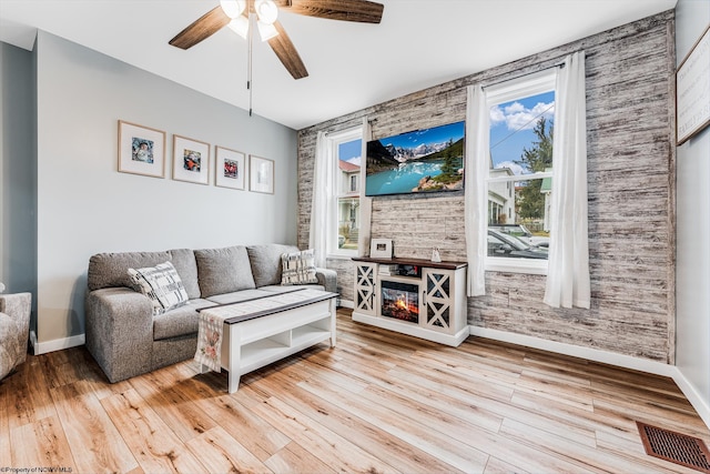 living room with ceiling fan and light hardwood / wood-style flooring