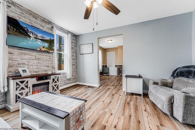 living room with ceiling fan and light wood-type flooring