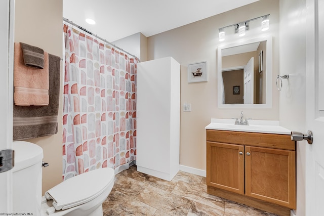 bathroom featuring vanity, a shower with shower curtain, and toilet