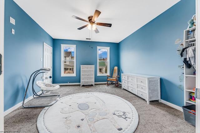 sitting room featuring ceiling fan and carpet