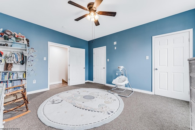 sitting room featuring carpet and ceiling fan