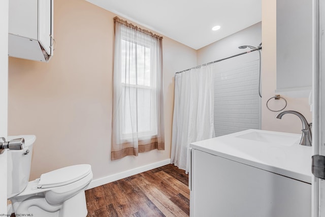 bathroom featuring sink, wood-type flooring, and toilet