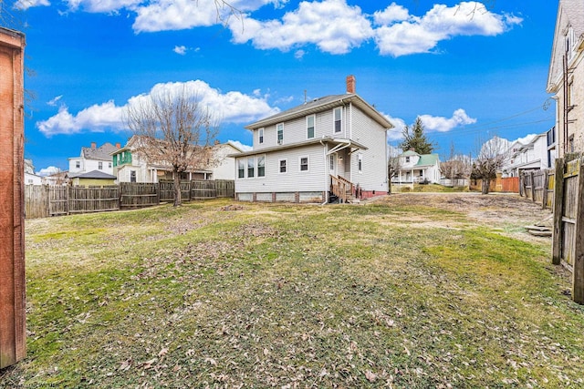 rear view of property with a yard