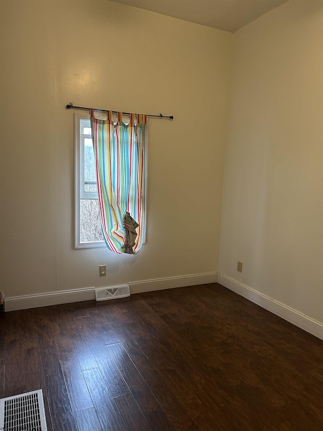 spare room with dark hardwood / wood-style flooring