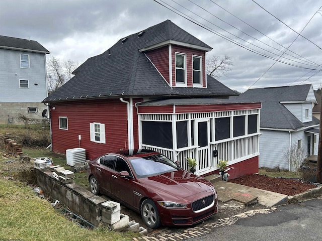 rear view of house featuring central air condition unit