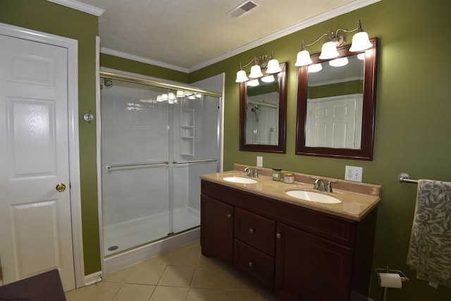 bathroom featuring ornamental molding, tile patterned floors, a shower with shower door, and vanity