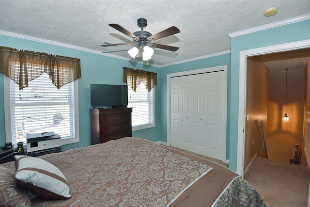 bedroom with ceiling fan, ornamental molding, a closet, and a textured ceiling