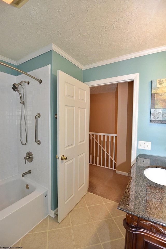 bathroom featuring crown molding, a textured ceiling, vanity, tiled shower / bath combo, and tile patterned flooring