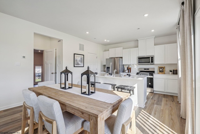 dining room with light hardwood / wood-style flooring