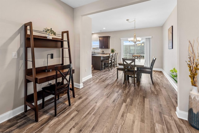 dining area featuring an inviting chandelier and hardwood / wood-style floors