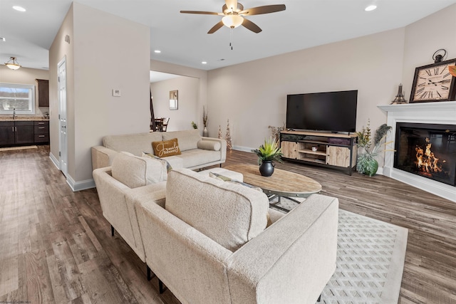 living room with sink, hardwood / wood-style floors, and ceiling fan