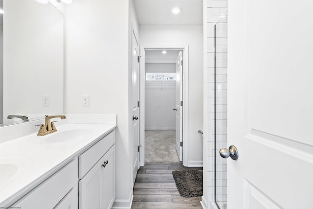 bathroom with vanity, hardwood / wood-style floors, and walk in shower