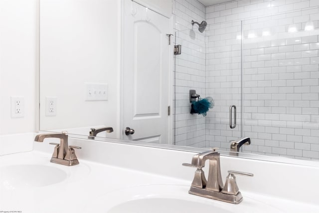 bathroom with walk in shower and vanity