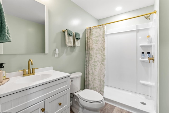 bathroom with vanity, hardwood / wood-style floors, a shower with shower curtain, and toilet