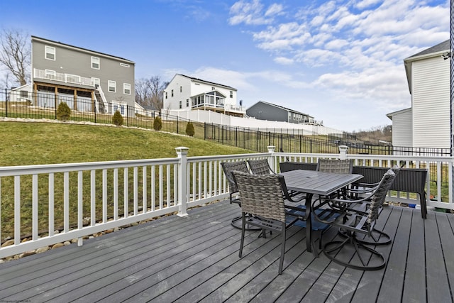 wooden terrace featuring a lawn