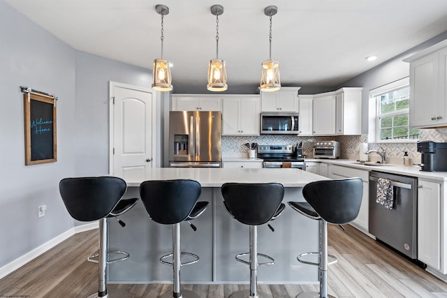 kitchen with a center island, white cabinets, and appliances with stainless steel finishes