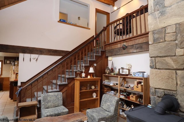 staircase with a high ceiling and tile patterned floors