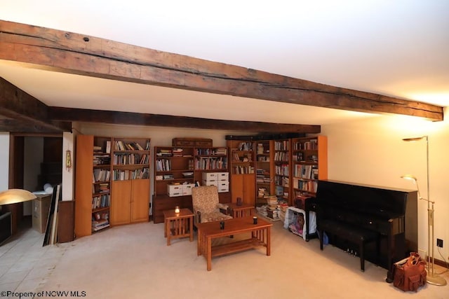 interior space featuring carpet floors and beam ceiling
