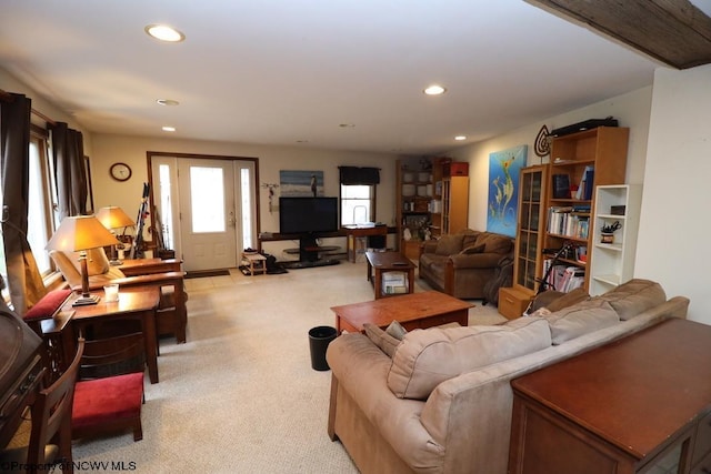 living area with recessed lighting and light colored carpet