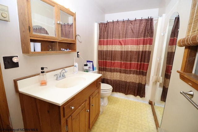 bathroom featuring shower / tub combo, toilet, vanity, and tile patterned floors