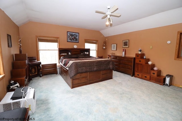 bedroom with lofted ceiling, a ceiling fan, and light colored carpet